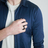 man wearing a black hammered tungsten wedding ring